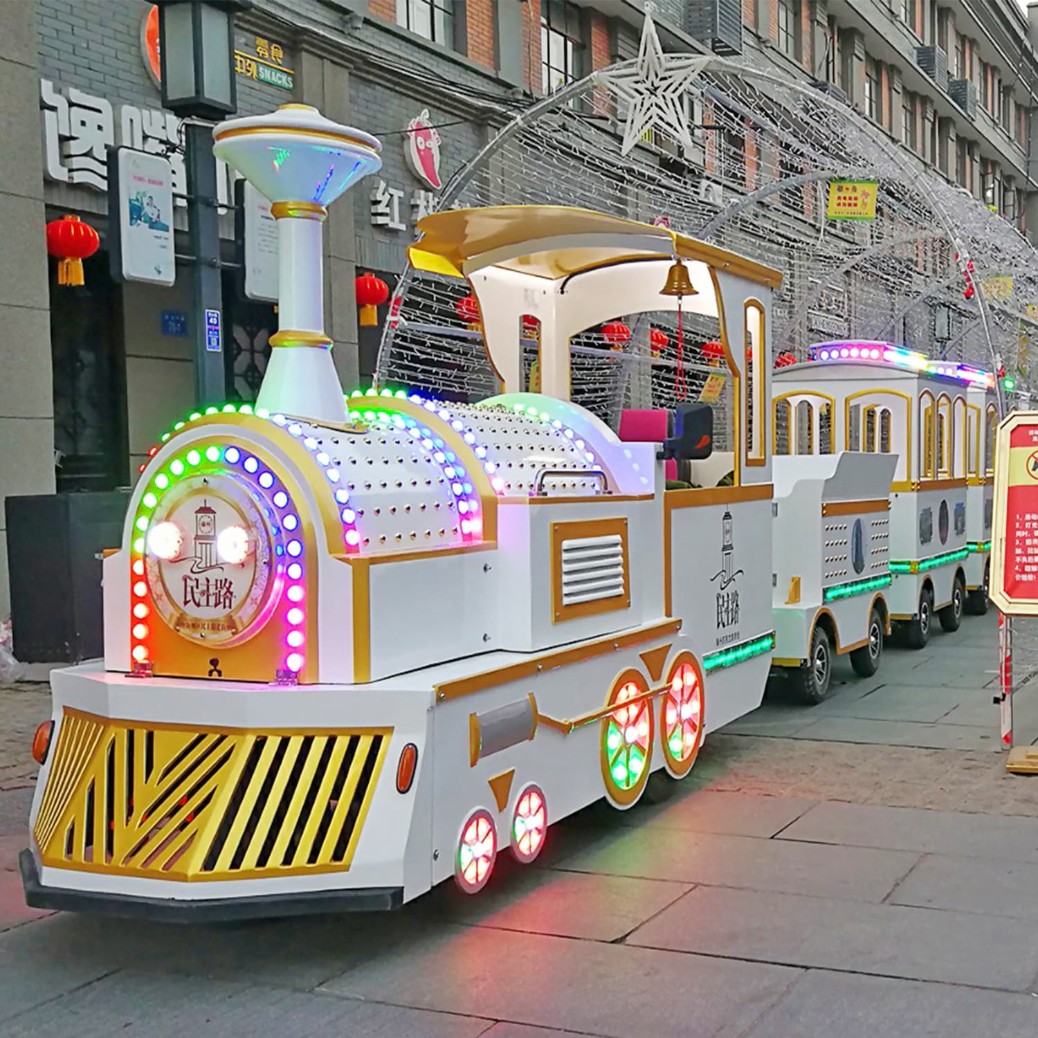 Modern trackless train with sleek design in blue and white