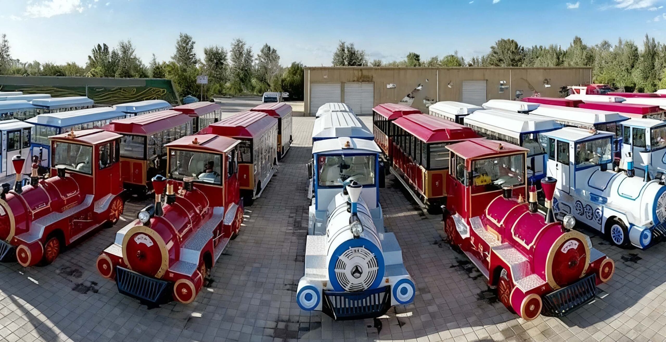 Trackless train moving through a park with passengers